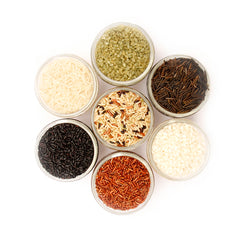Overhead image of assorted rices in glass jars.